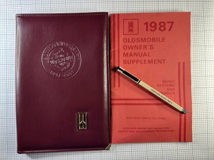 1987 90th Anniversary Oldsmobile Manual Cover w/ Pen & Supplement